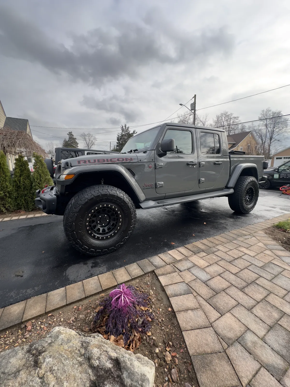 Grey Jeep Gladiator Rubicon detailed in the driveway