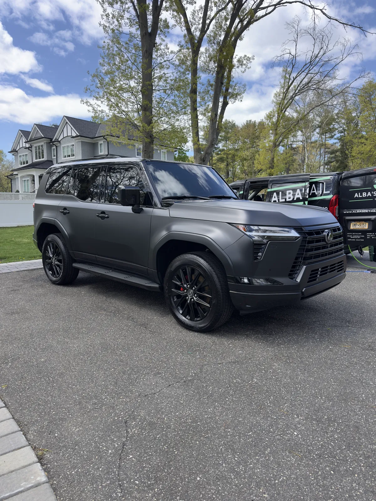 Matte grey Lexus LX detailed beside the Alba's Detail Studio van